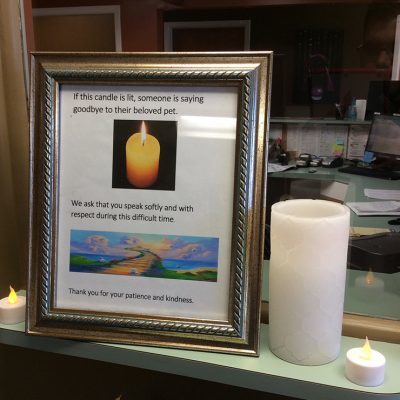 framed sign informing other clients that someone is saying goodbye to their pet when a candle is lit